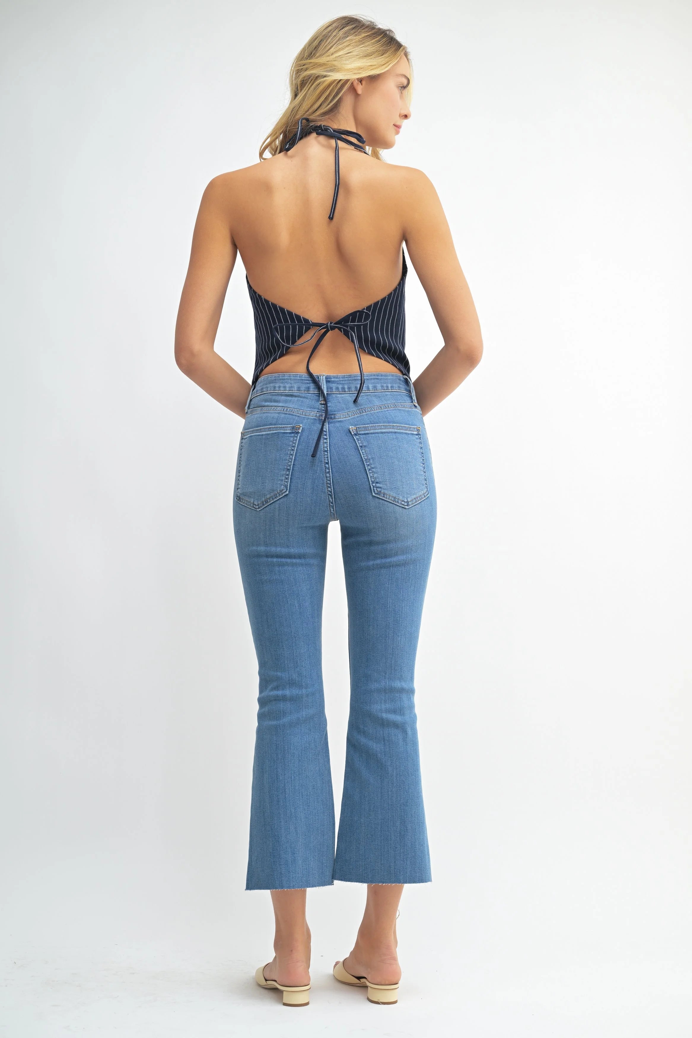 Woman modeling denim on a white background.
