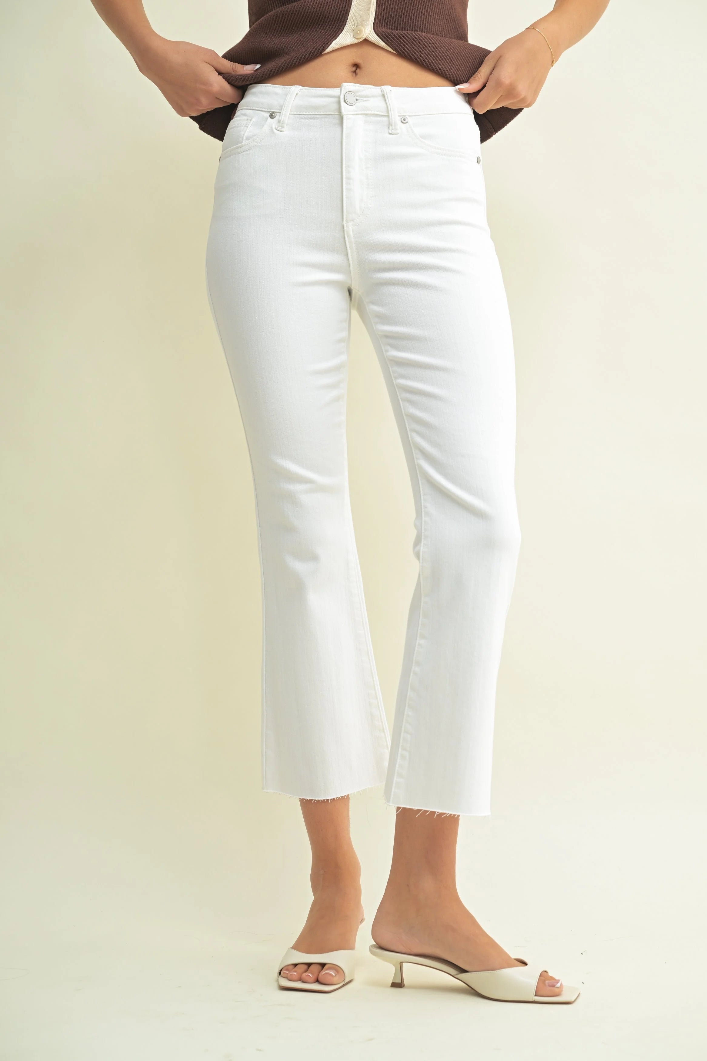 Woman modeling denim on a white background.