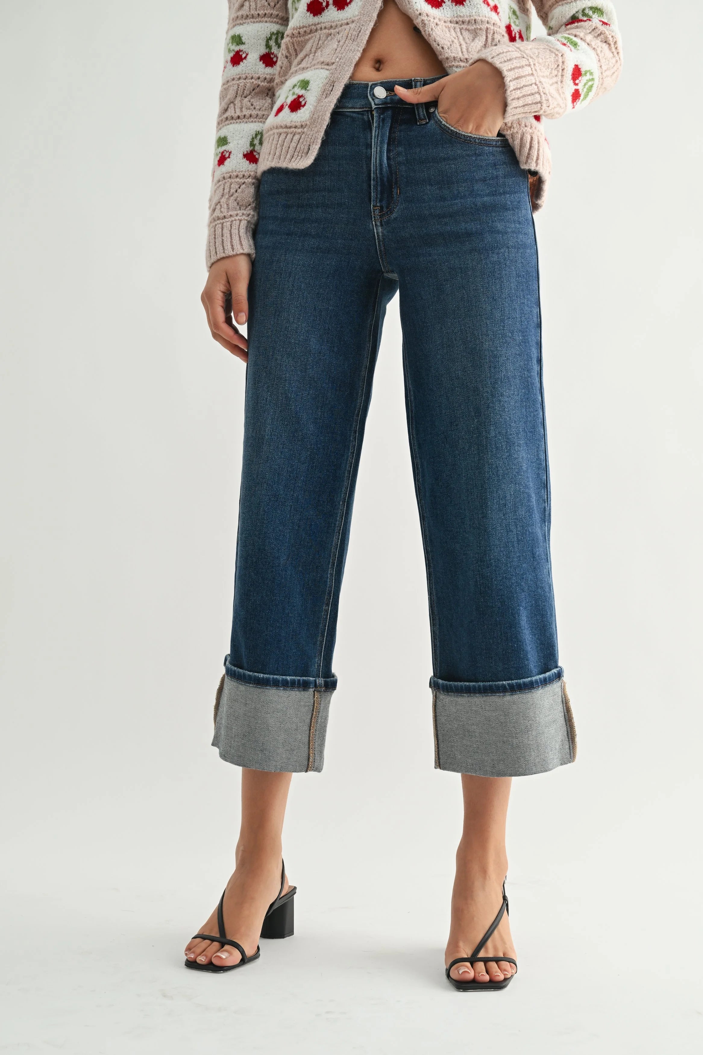 Person wearing blue jeans with a white background