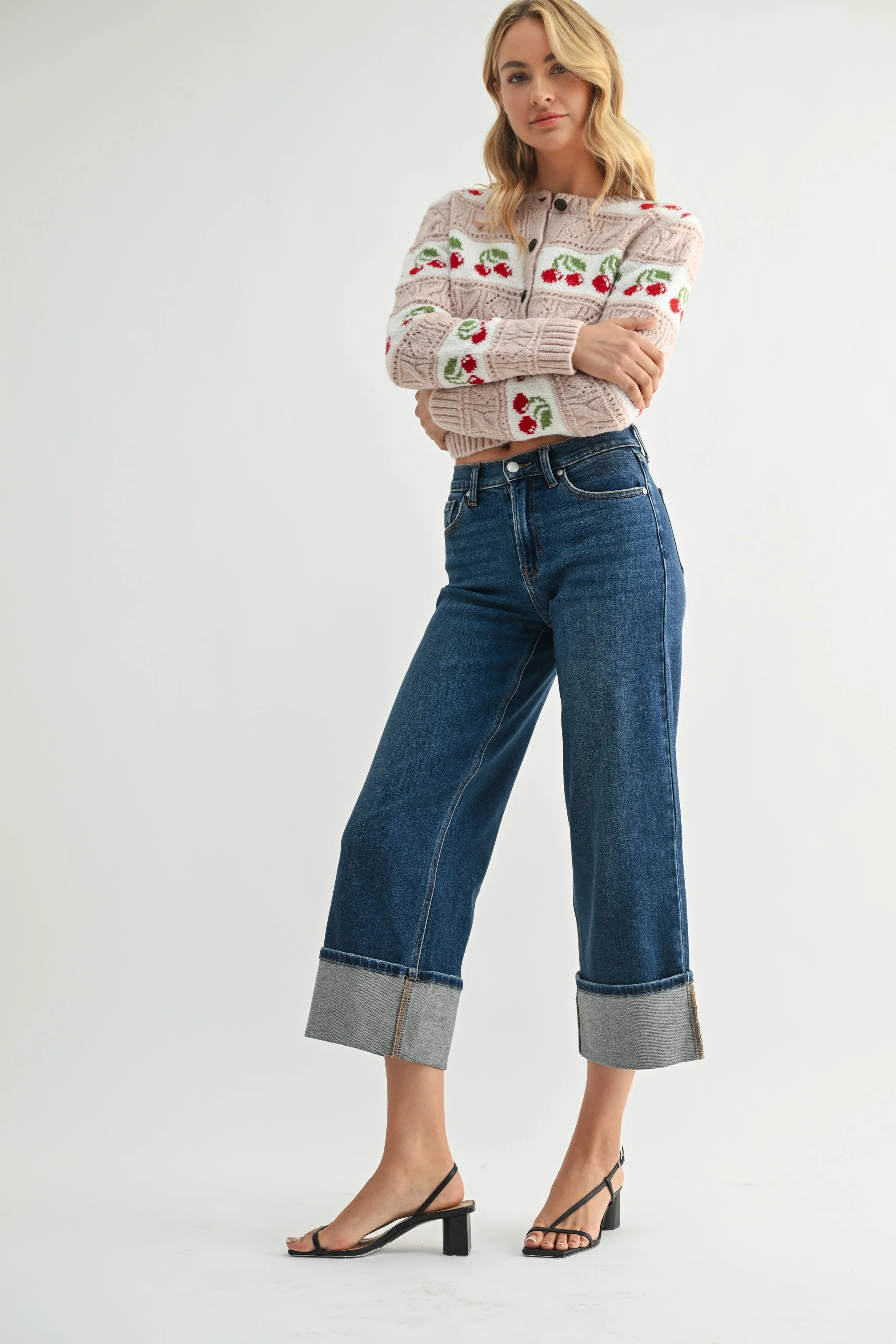 Woman modeling denim on a white background.