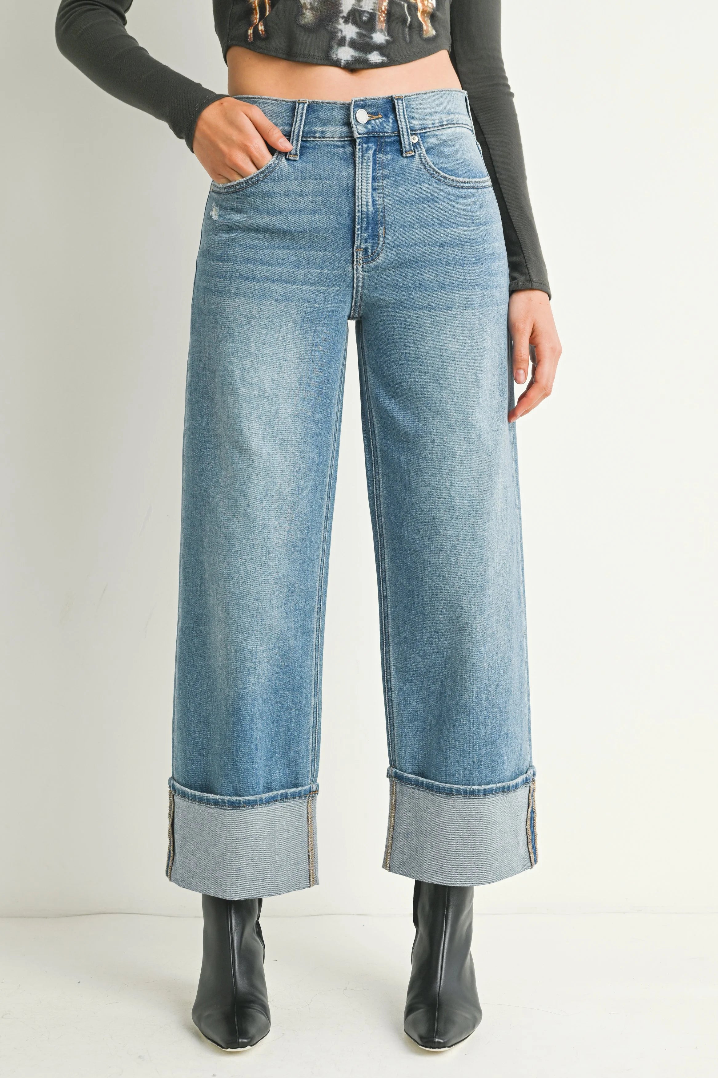 Woman modeling denim on a white background.