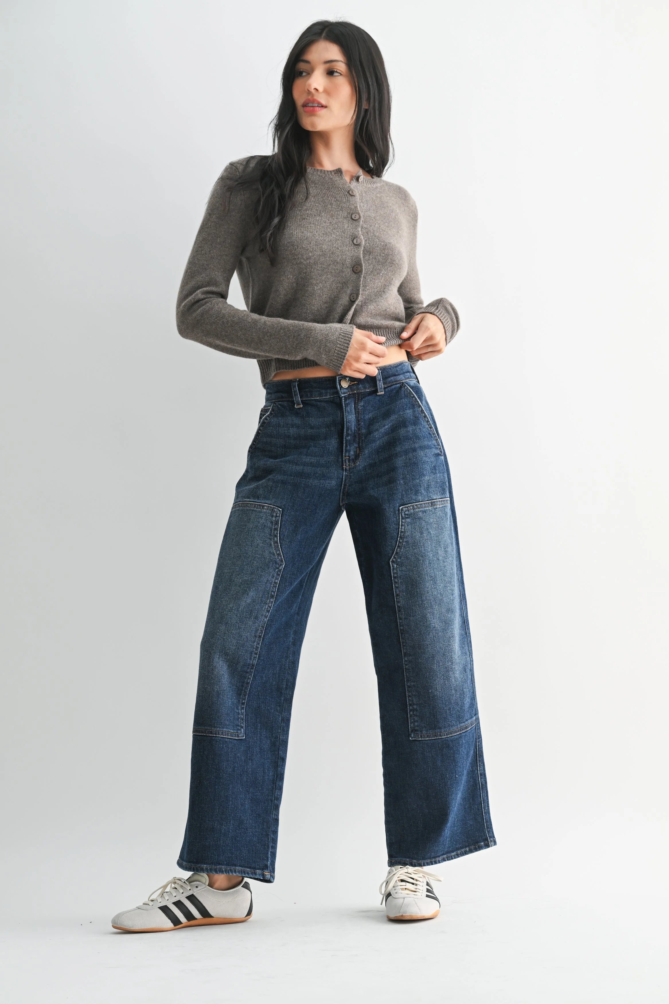 Woman modeling JBD denim on a white background.