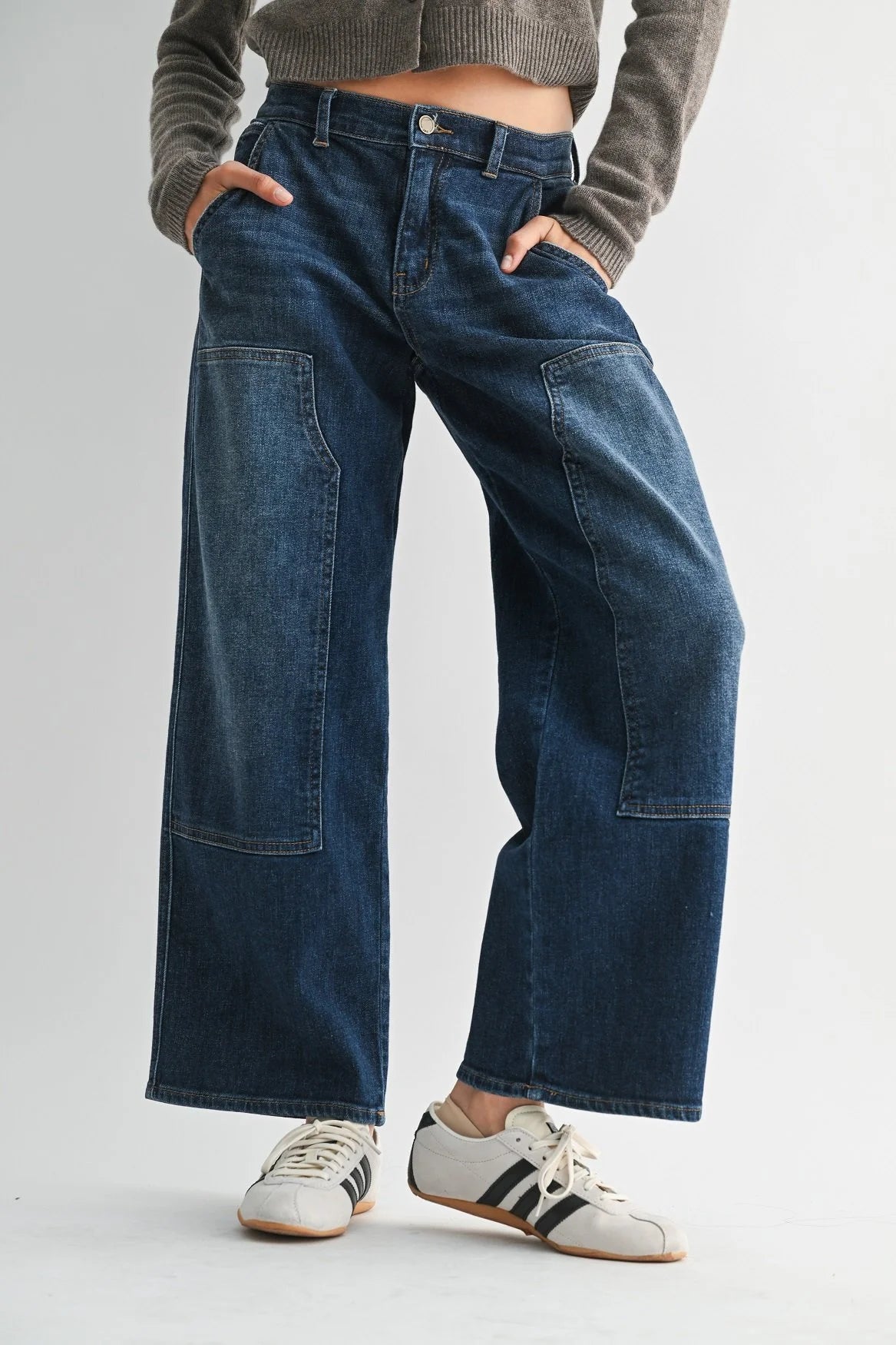 Woman modeling JBD denim on a white background.
