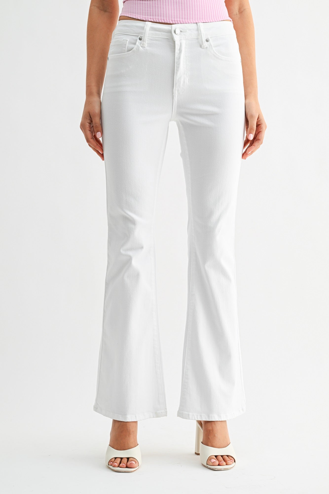 White jeans worn by a person on a white background