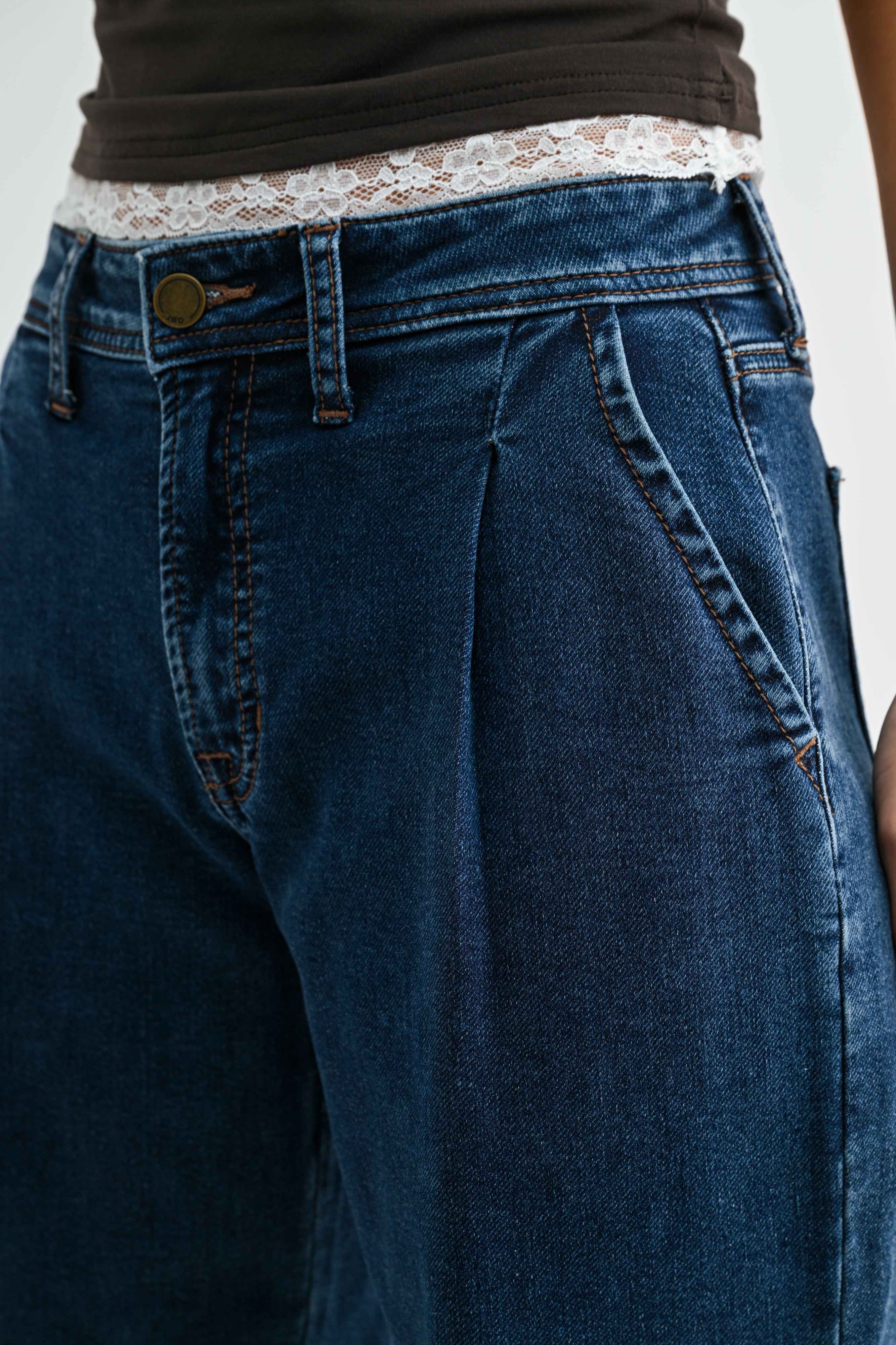 Close-up of blue jeans with a plain background