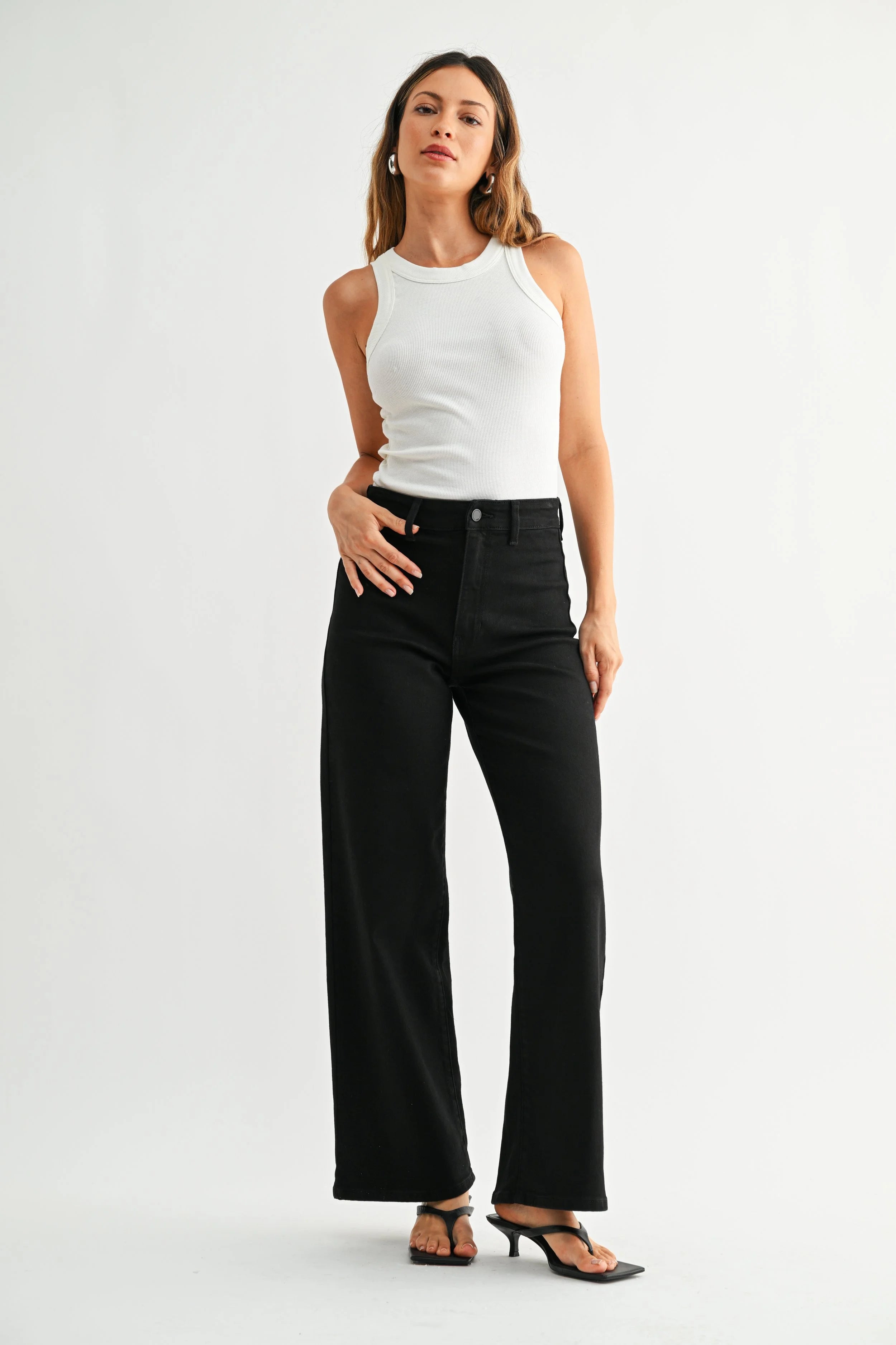 Woman modeling JBD denim on a white background.
