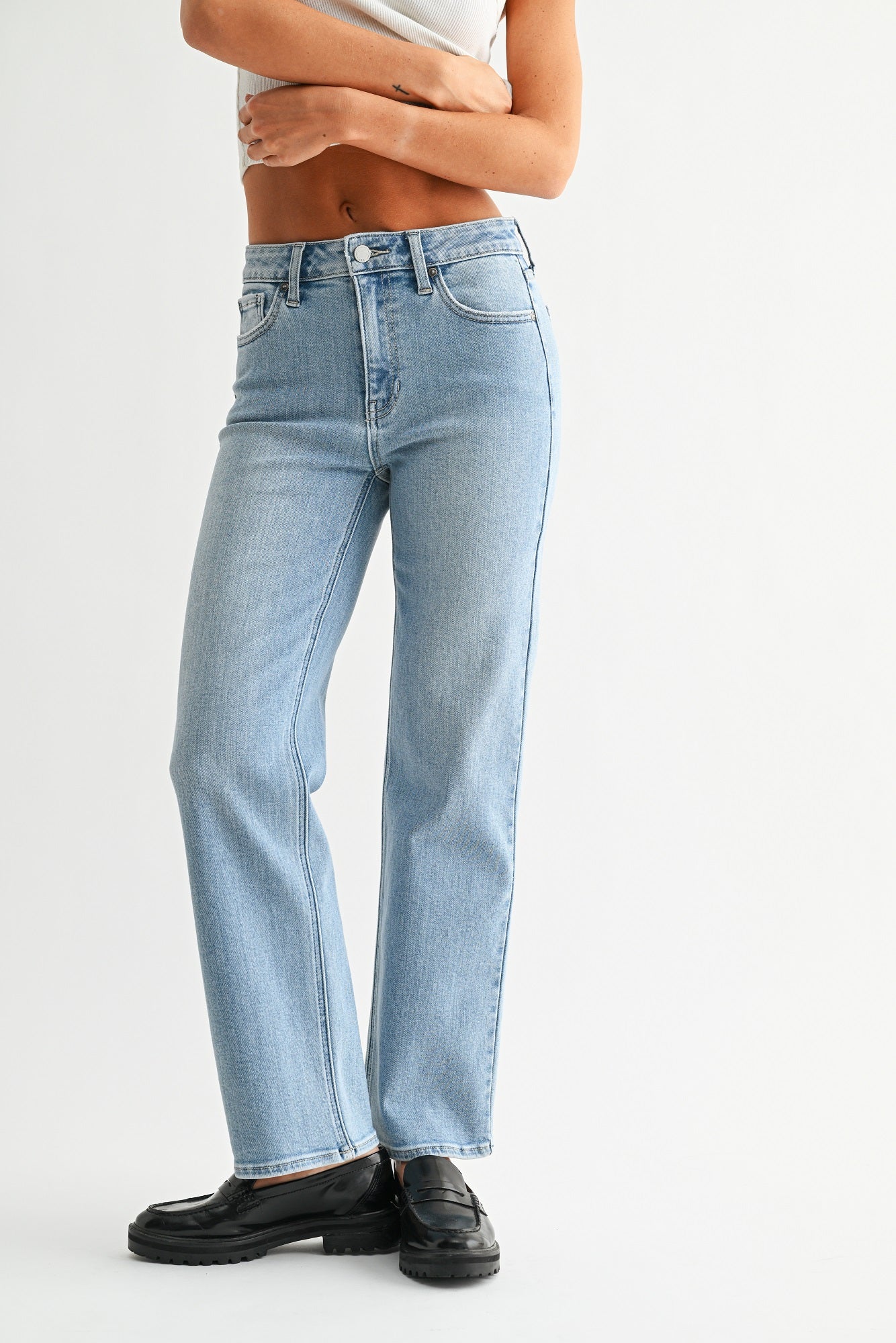 Light blue jeans worn by a person on a white background