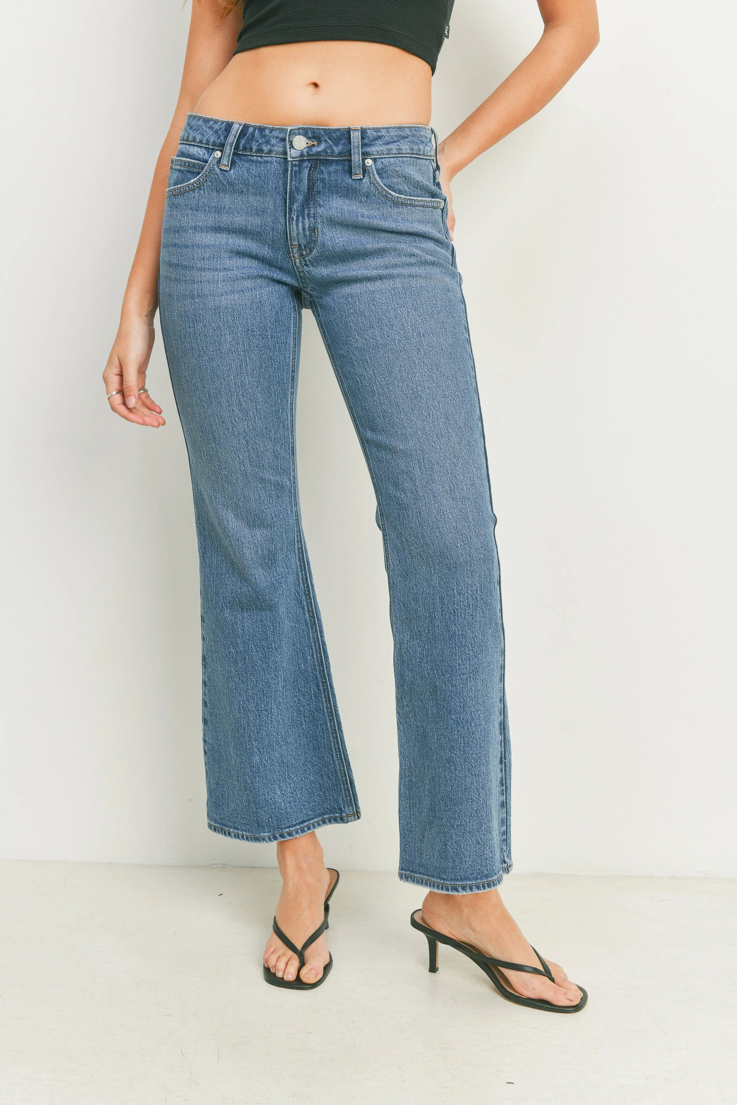 Person wearing blue jeans on a white background